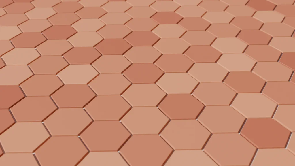 Gros plan sur des tomettes hexagonales en terre cuite aux teintes variées, séparées par de fins joints